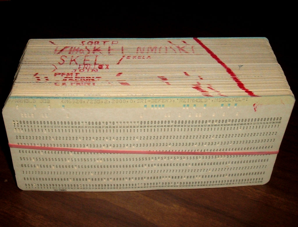 A single program deck, with individual subroutines marked. The markings show the effects of editing, as cards are replaced or reordered.